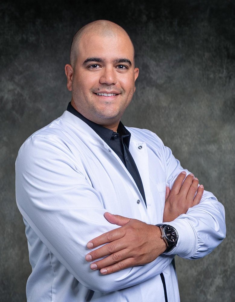Dr. Ruben G. Daboin, DDS, in his white coat