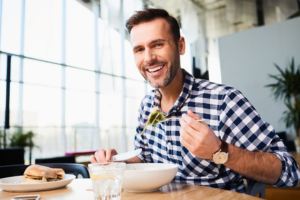 A man enjoying a meal comfortably at his kitchen table